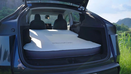 Model y juniper trunk with a model y camping mattress pro on a scenic outdoor background